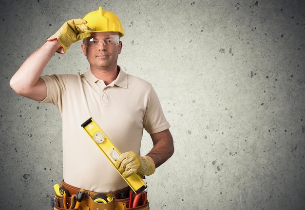 Portrait of handsome man in work uniform and yellow helmet