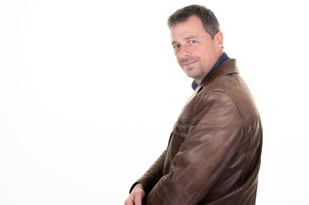 Portrait of handsome serious mature man in leather jacket with copy space on white background