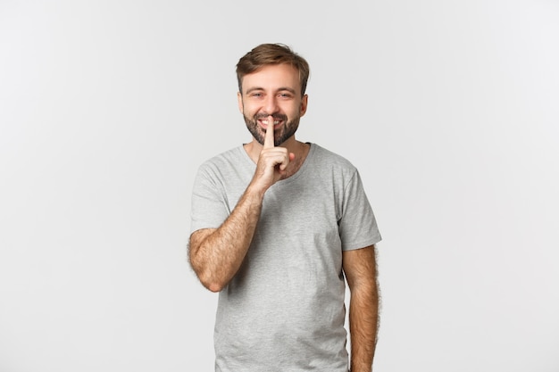 Portrait of handsome smiling man in grey t-shirt