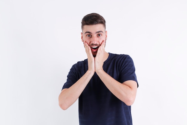 Portrait of handsome smiling shocked stylish young man model