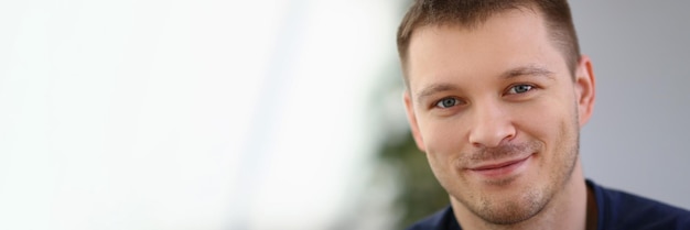 Portrait of handsome smiling young man with stubble