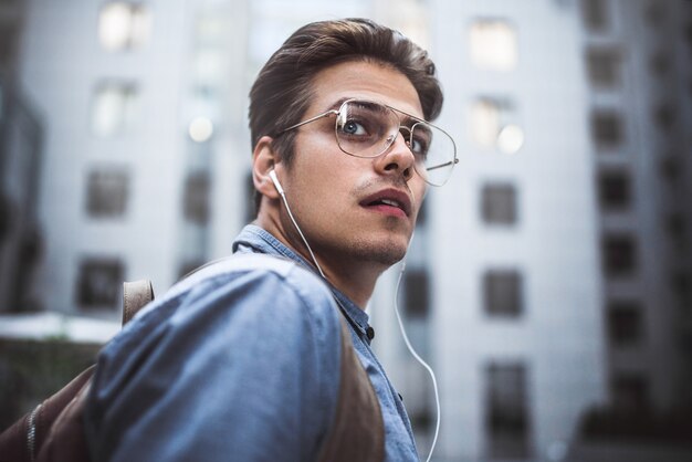 Portrait of handsome successful businessman walking on the street and thinking about startup project