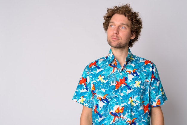 Portrait of handsome tourist man with curly hair on white