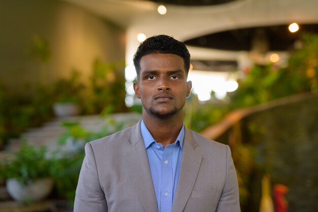 Portrait of handsome young African businessman looking at front