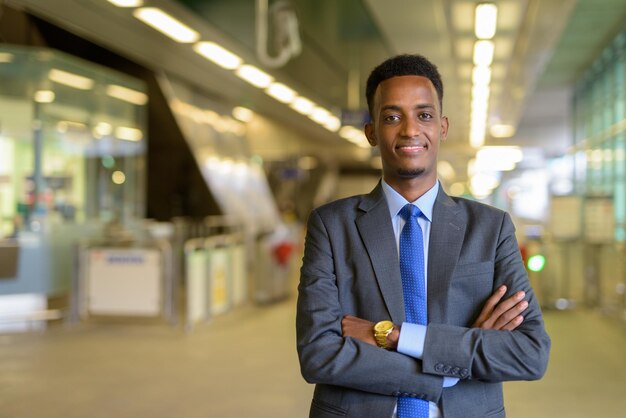 Portrait of handsome young African businessman wearing suit and tie