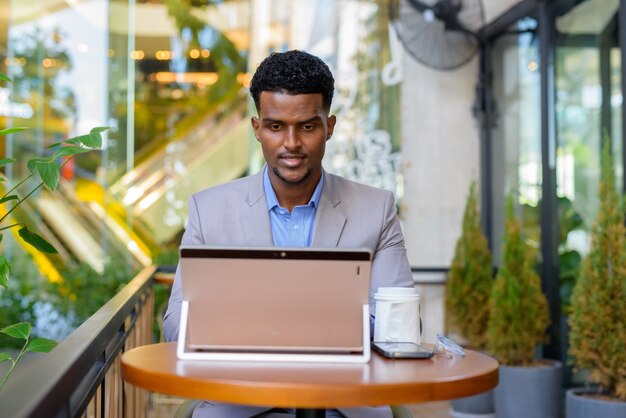 Portrait of handsome young African businessman wearing suit