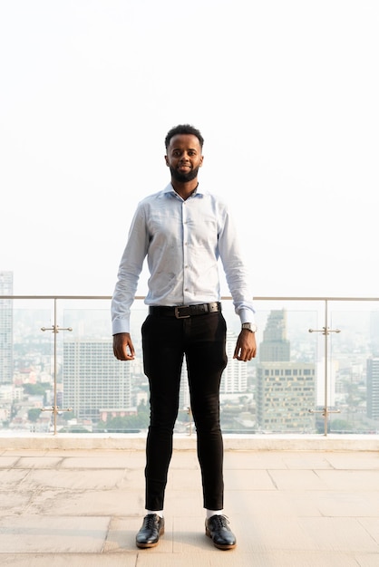 Portrait of handsome young African man full length shot