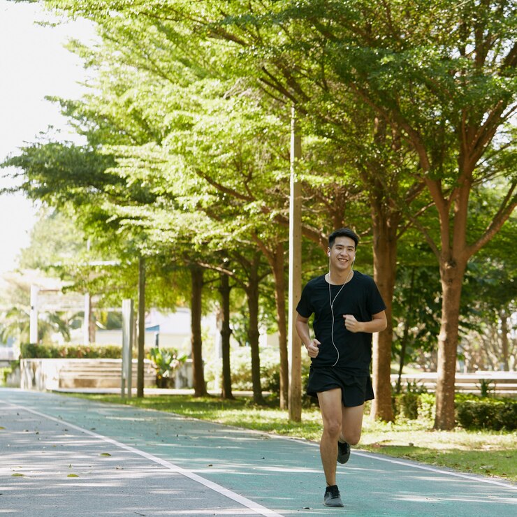 Photo 훈련 음악을 듣고 조깅 잘 생긴 젊은 아시아 남자 운동가의 초상화