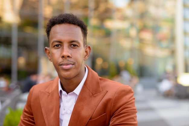 Portrait of handsome young black African businessman wearing stylish clothes