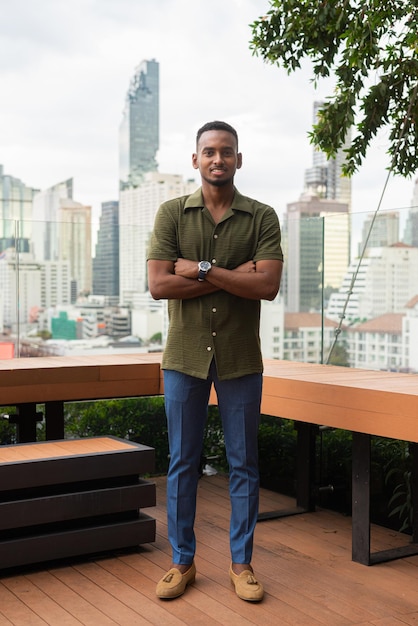 Portrait of handsome young black man outdoors in city