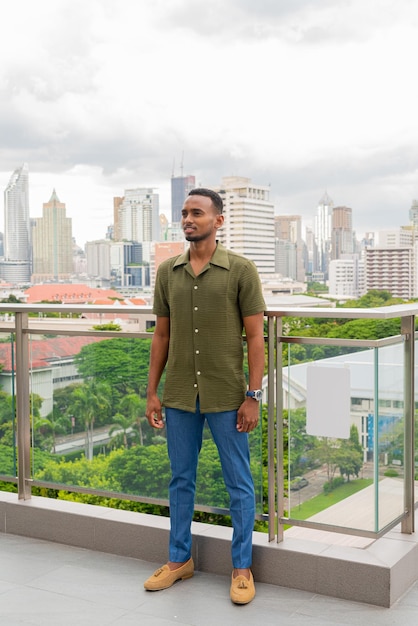 Portrait of handsome young black man outdoors in city