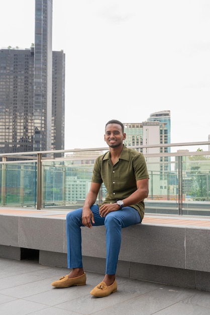 Portrait of handsome young black man outdoors in city