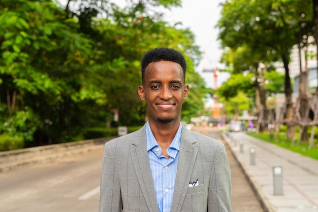 Portrait of handsome young black man outdoors in city