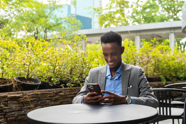 Portrait of handsome young black man outdoors in city