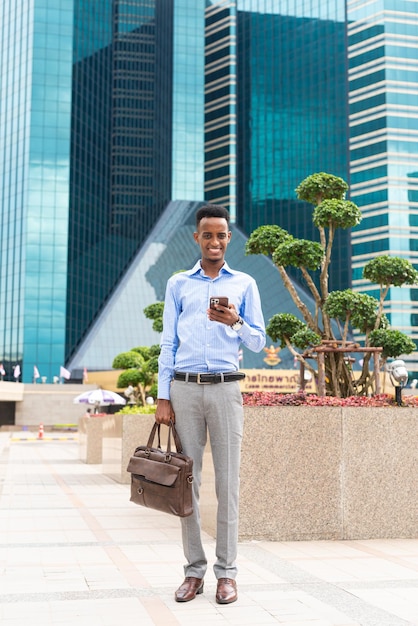 Portrait of handsome young black man outdoors in city