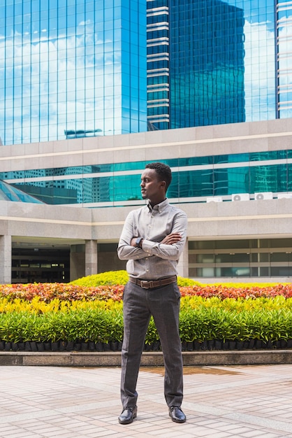 Portrait of handsome young black man outdoors in city