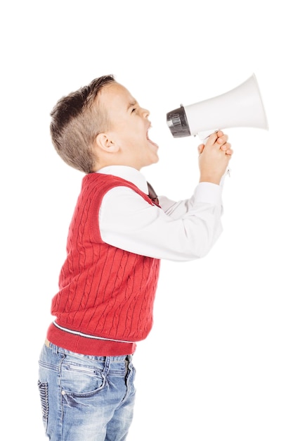 Portrait handsome young boy shouting with megaphone on white studio background xA