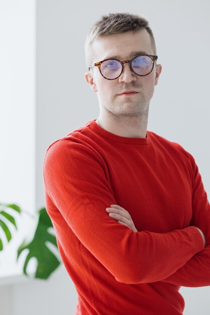 Portrait of a handsome and young caucasian man in a red sweater