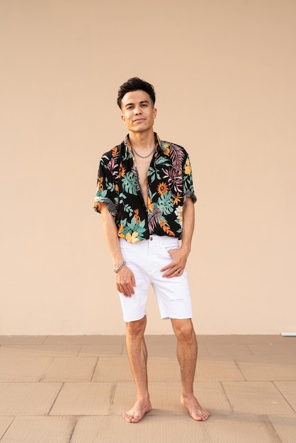 Portrait of handsome young cool man against plain background