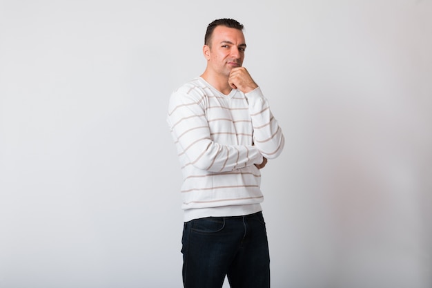 portrait of handsome young man against white wall