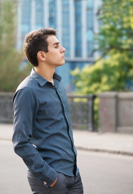 Portrait of the handsome young man in front of the historic building