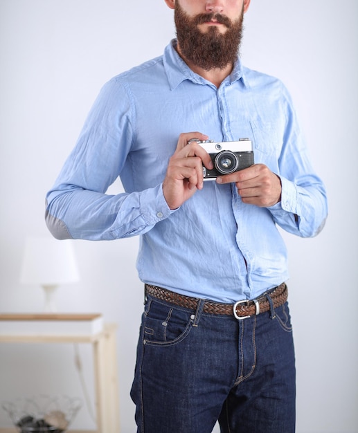 Portrait of a handsome young man holding a camera