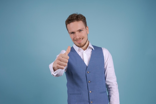 Portrait handsome young man makes normal gesture shows consent loves idea