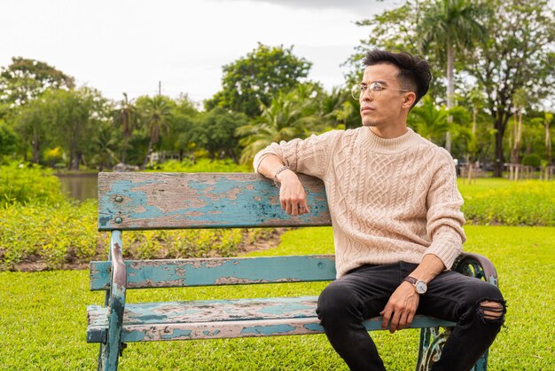 Portrait of handsome young man in park during summer