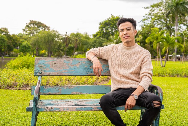 Portrait of handsome young man in park during summer