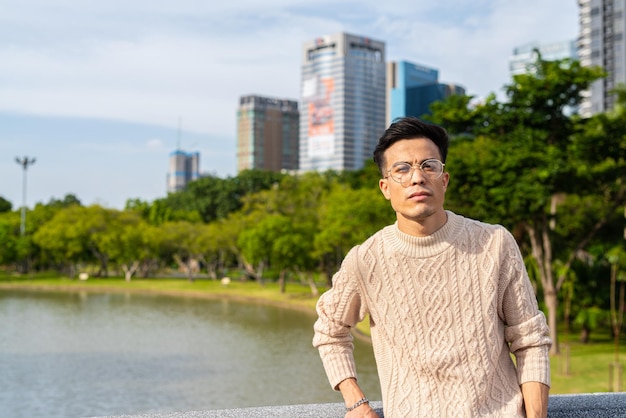 Portrait of handsome young man in park during summer