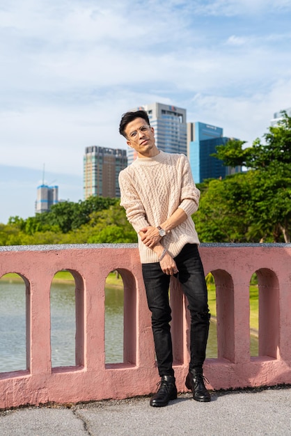 Portrait of handsome young man in park during summer