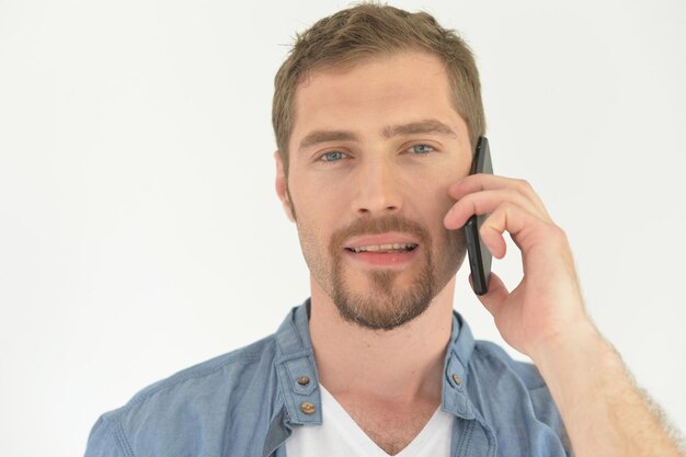 Portrait of handsome young man talking on smartphone