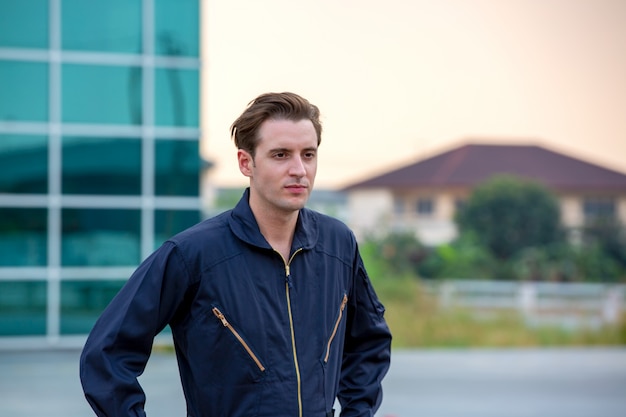 portrait of a handsome young man in technician engineer uniform gesture against airport