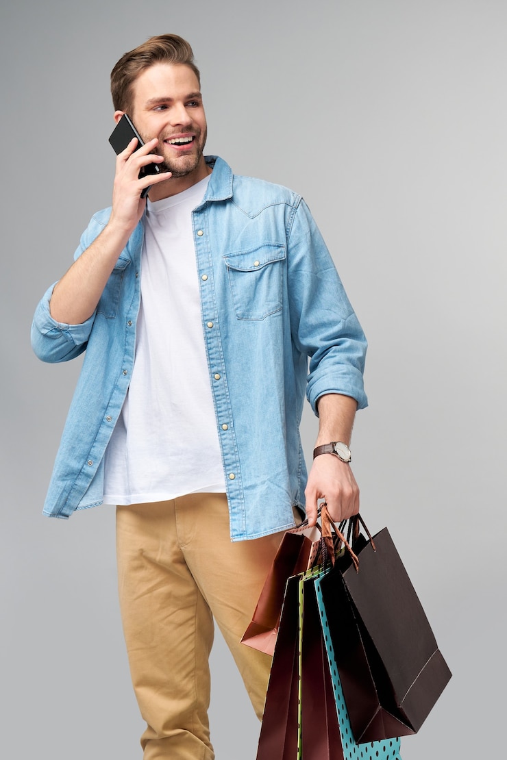 Photo portrait of a handsome young man with shopping bags.