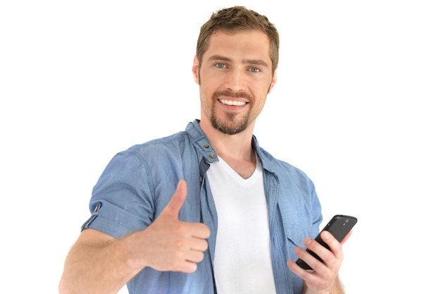 Portrait of a handsome young man with a smartphone in hand on a white background