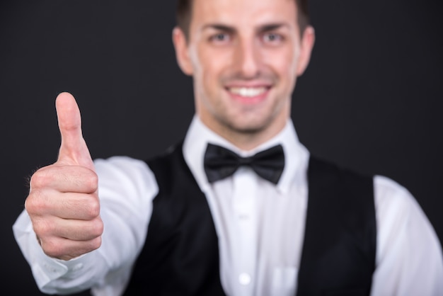 Portrait of a handsome young smiling man in a suit.