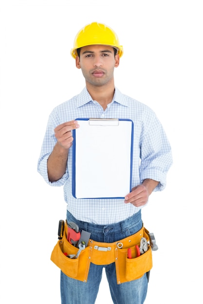 Portrait of a handyman in yellow hard hat holding a clipboard