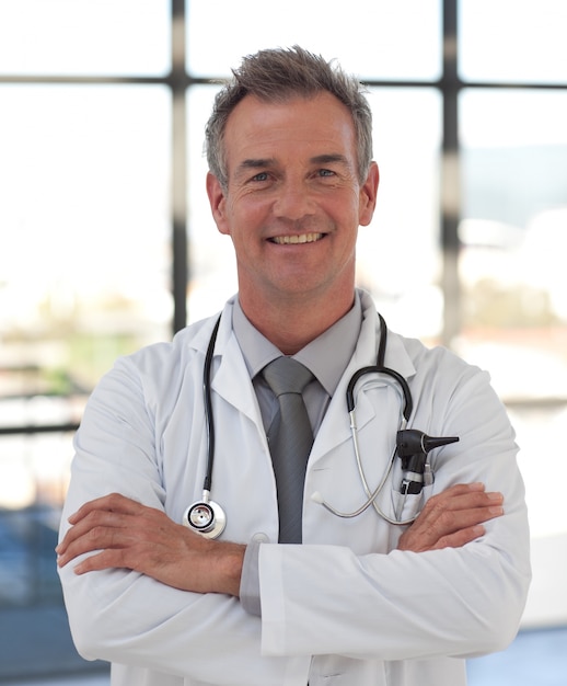 Portrait of a hansdome doctor standing at hospital