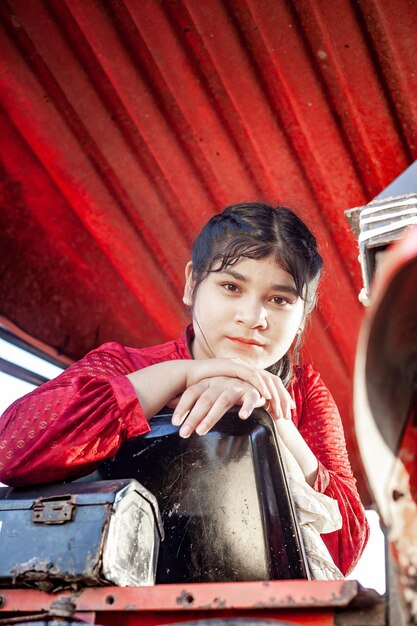 Photo portrait of happiness pretty beautiful chubby girl with red dress posing with vintage car