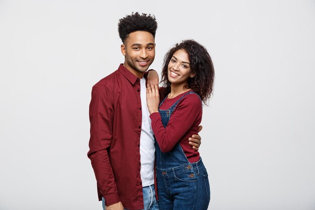 Portrait of happy african american couple hug each other on white background