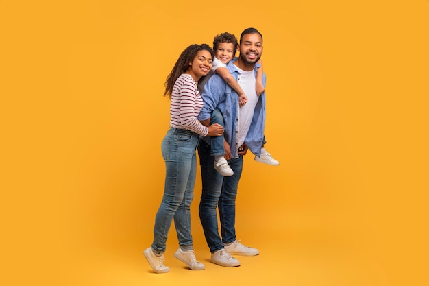 Portrait of happy african american family of three with preteen son