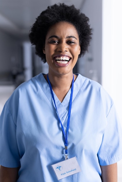 Portrait of happy african american female doctor in hospital corridor