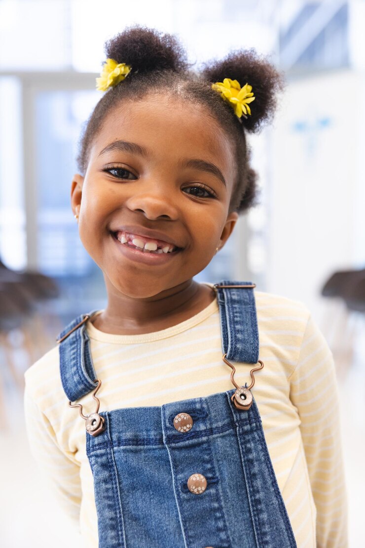 Photo portrait of happy african american girl patient in waiting room at hospital. hospital, childhood, medicine and healthcare, unaltered.