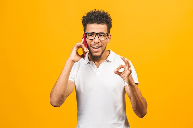 Portrait of a happy african american guy talking on mobile phone