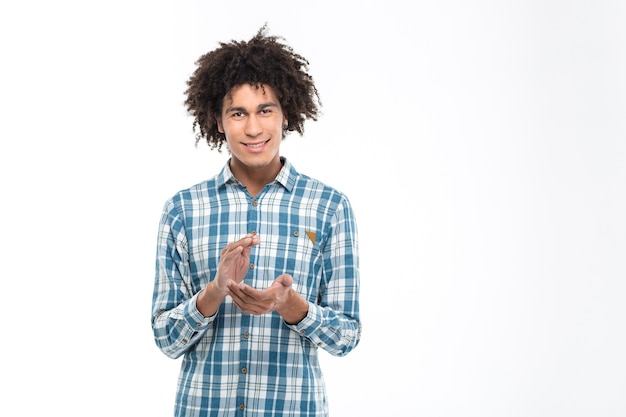 Photo portrait of a happy afro american man clapping hands isolated on a white wall