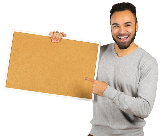 Portrait of a happy afro american man holding blank board isolated on a white