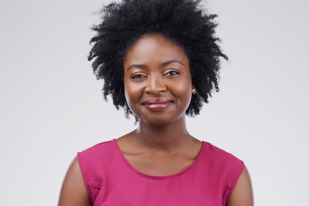 Portrait happy and afro with a black woman in studio on a gray background for beauty or fashion Face smile and natural with an attractive young female person feeling confident in trendy clothes