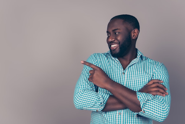 Portrait of happy afroamerican  bearded  man pointing something on copy space