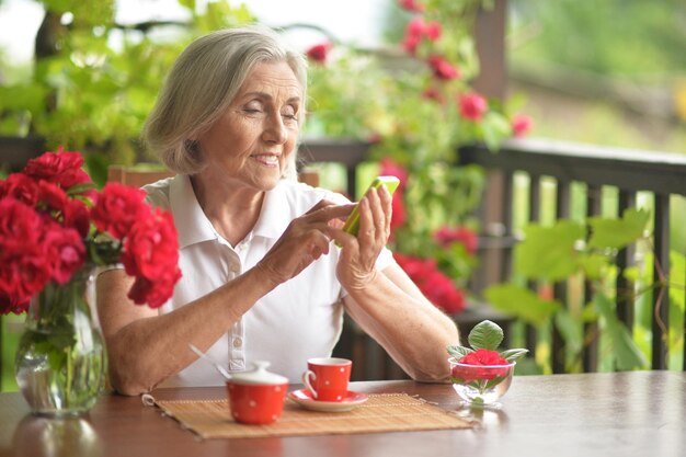 Portrait of a happy aged woman talking on smartphone