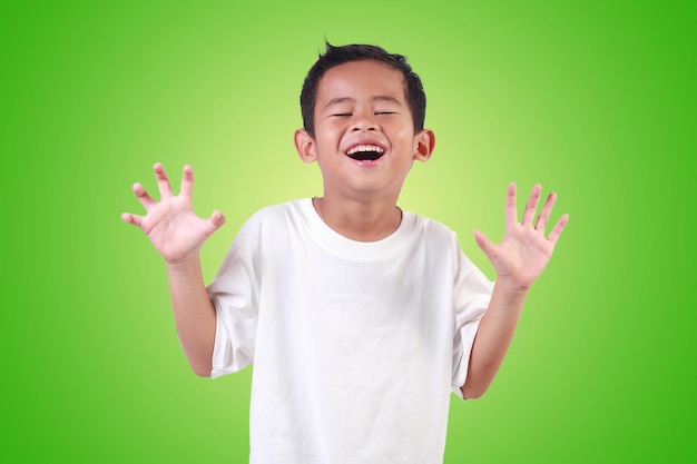 Portrait of happy Asian boy with black hair wearing white shirt laughing and rising his hands up